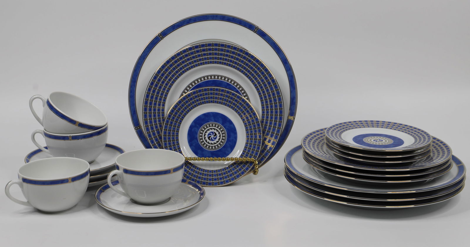 Christofle China, Micro Gold Dishes: Four, 5 piece porcelain place settings; Salad and dessert plates are in the "Oceana Bleu" pattern; Dinner plate, cups and saucers are in the "Micro Gold" pattern; Dinner plates measures approximately