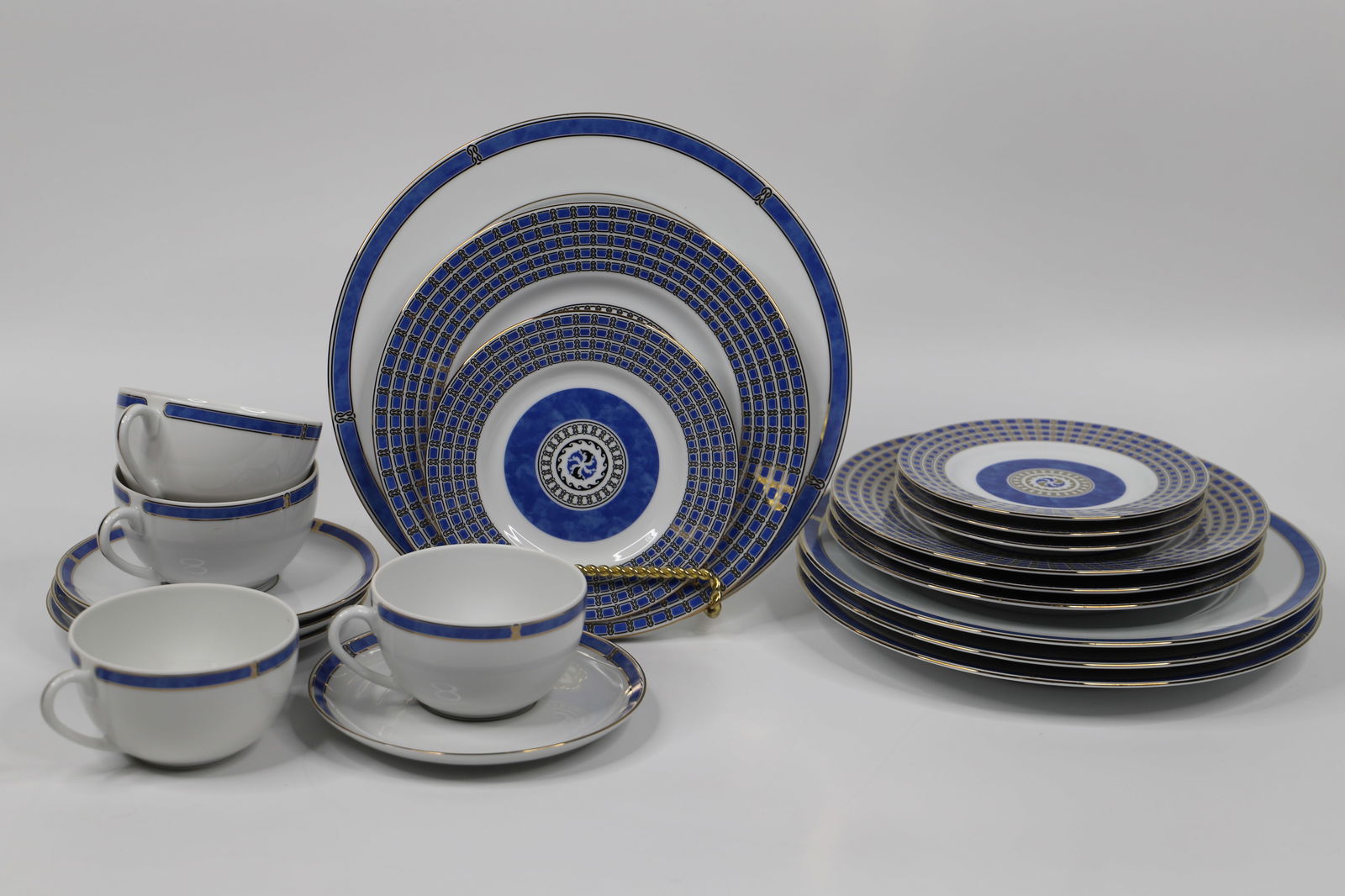 Christofle Porcelain, Micro Gold Dishes: Four, 5 piece porcelain place settings; Salad and dessert plates are in the "Oceana Bleu" pattern; Dinner plate, cups and saucers are in the "Micro Gold" pattern; Dinner plates measures approximately