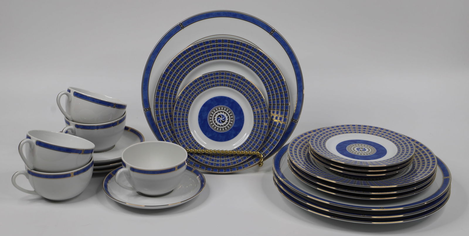 Christofle Porcelain, Micro Gold Dishes: Four, 5 piece porcelain place settings; Salad and dessert plates are in the "Oceana Bleu" pattern; Dinner plate, cups and saucers are in the "Micro Gold" pattern; Dinner plates measures approximately