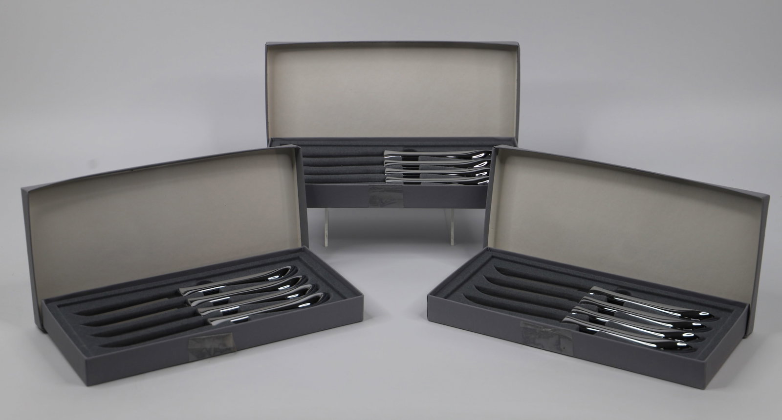 Neiman Marcus, Knives: Three boxes of knives for a total of 12; They are marked "Neiman Marcus", Each knife measures approximately H 8 3/4 inches; Some blades are stained; Boxes are taped.. See photos