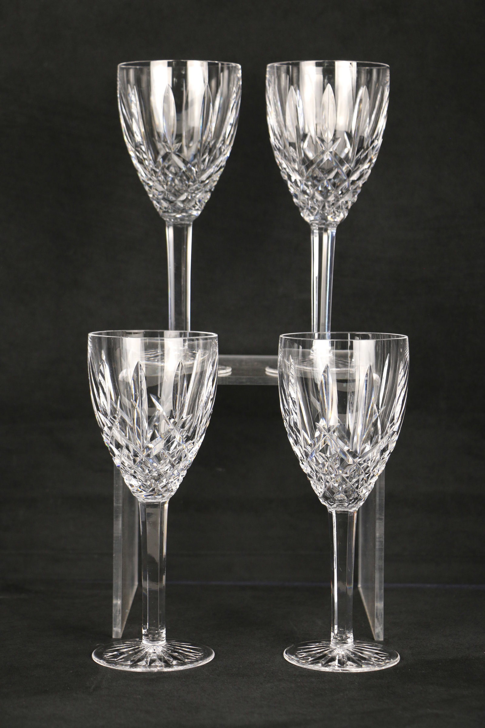 Waterford Crystal, Wine Glasses: Four wine glasses with the "Waterford" mark on the bases; Each glass measures approximately H 8 x Diameter 3 1/4 inches; No damage observed. See photos
