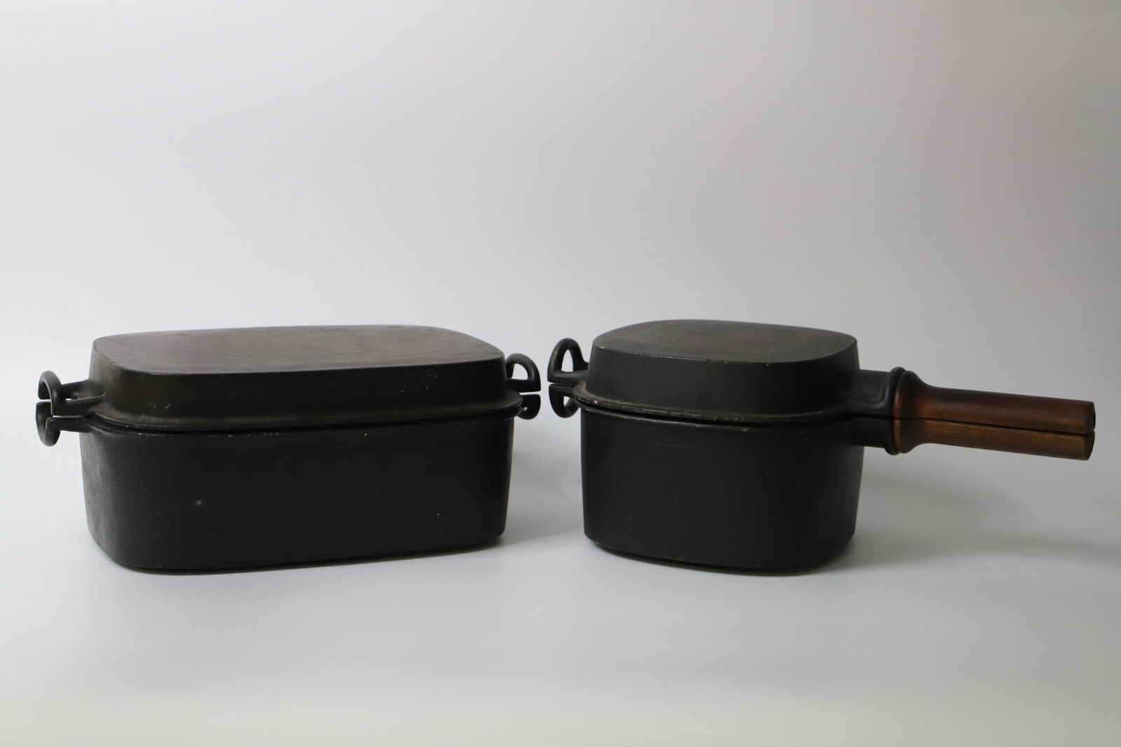 Dansk, Orecast Pots: Enamel lined, cast iron pot with lid and a dutch oven; Marked "Dansk Designs Finland" on the base; Dutch oven measures approximately 5 1/2 x W 13 x D 7 1/2 inches; Both in used condition. See photos