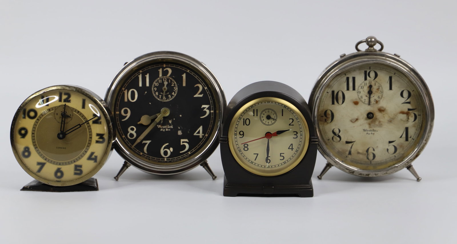 Westclox, Ingraham, Alarm Clocks: Two Westclox "Big Ben"; Ingraham "Corning"; Pottery Barn clock measures approximately H 4 inches; Glass missing on one Big Ben and hands are missing on the other; Working conditions unknown. See photo