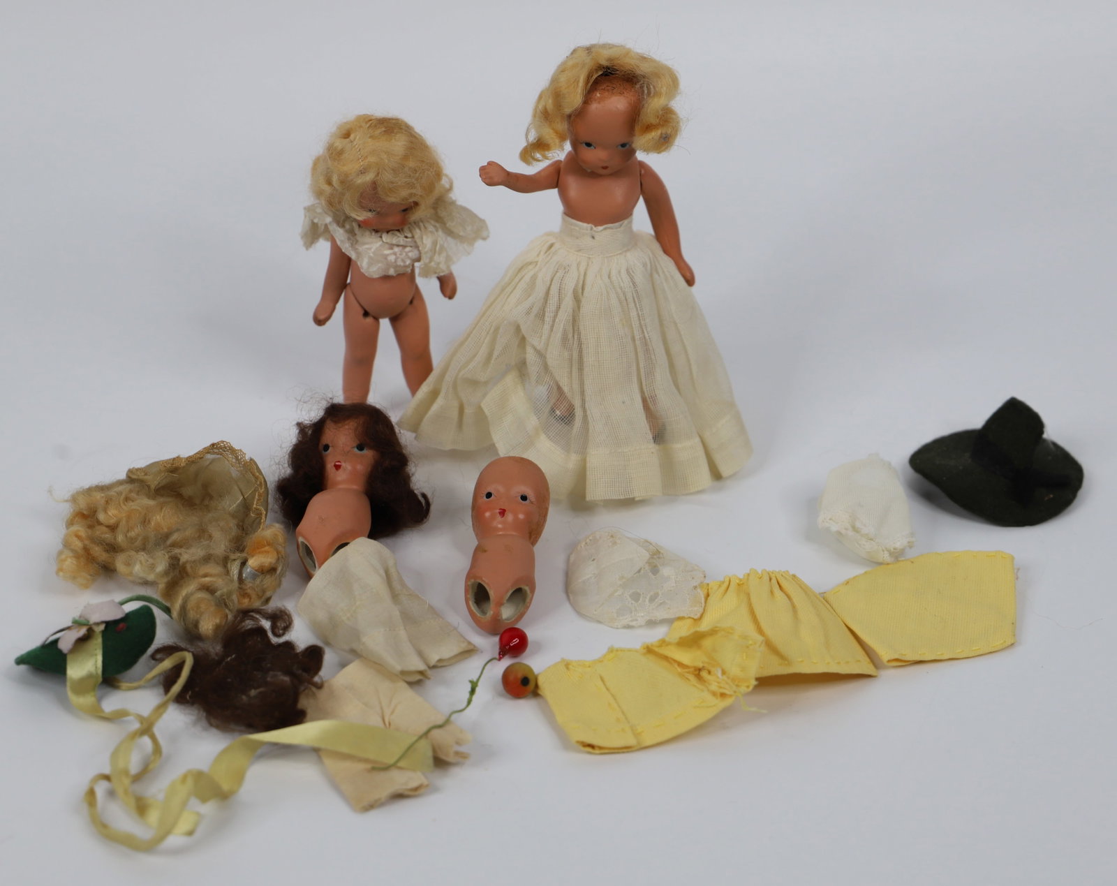 Nancy Ann, Storybook Dolls: Four ceramic Nancy Ann Storybook Dolls; Accessories including undergarments, clothing and hair; Tallest doll measures approximately H 6 x W 2 x D 2 1/2 inches; Two dolls do not have arms or legs, chip