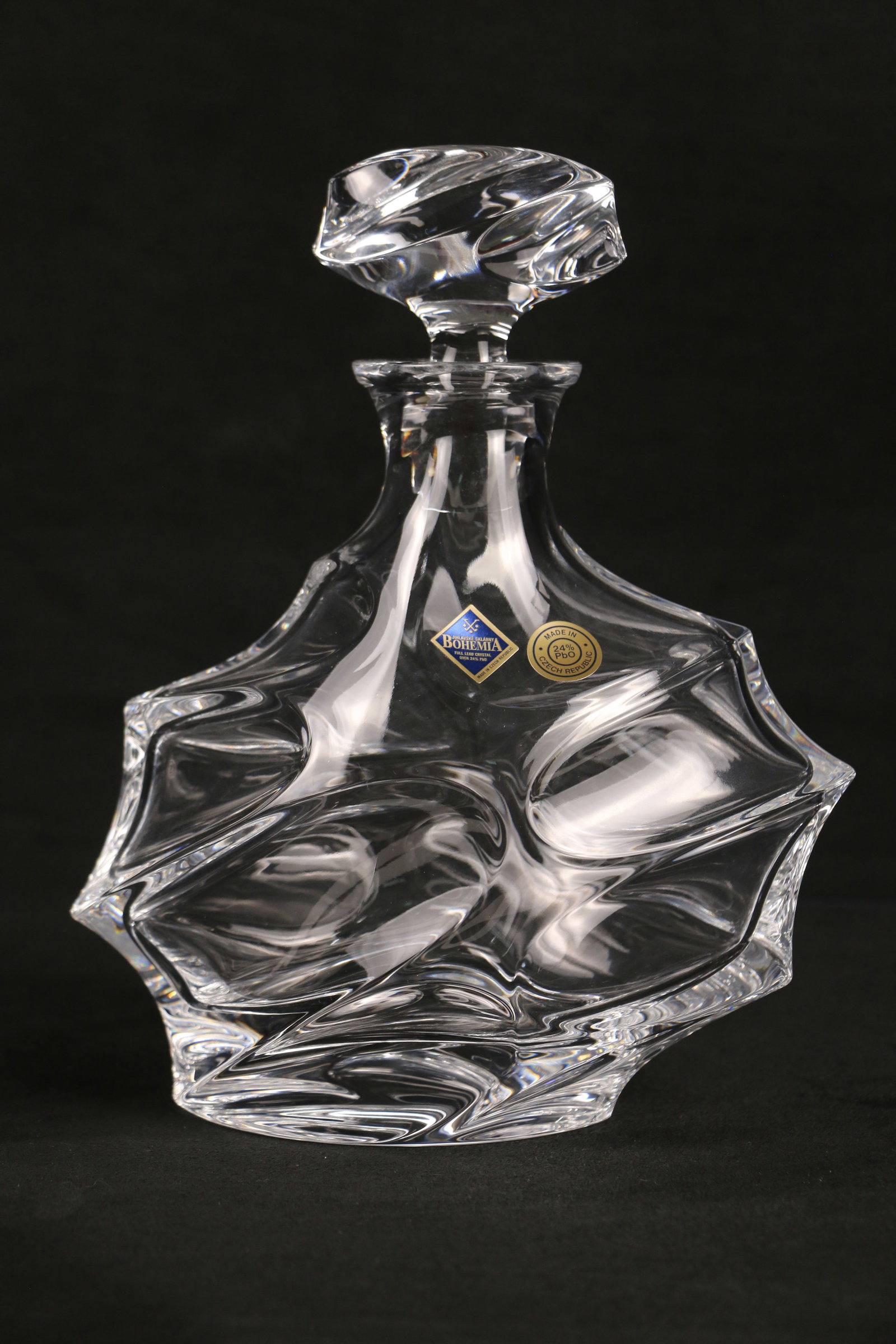 Bohemia, Crystal Decanter: Crystal decanter with paper labels attached; Made in the Czech Republic; Measures approximately H 10 x W 8 x D 4 1/4 inches; No damage observed. See photos
