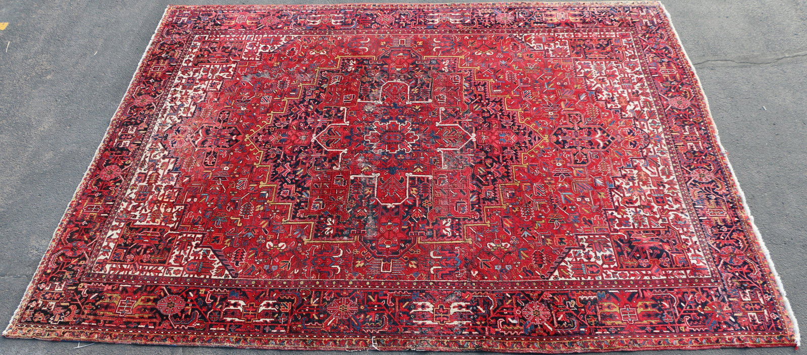 Persian Rug: Large vintage area rug; Marked "Made in Iran"; Possibly Heriz; Wool and cotton blend; Circa 1970's; Measures approximately H 154 x W 117 1/2 inches; In used condition; Moth damaged, especially in the 