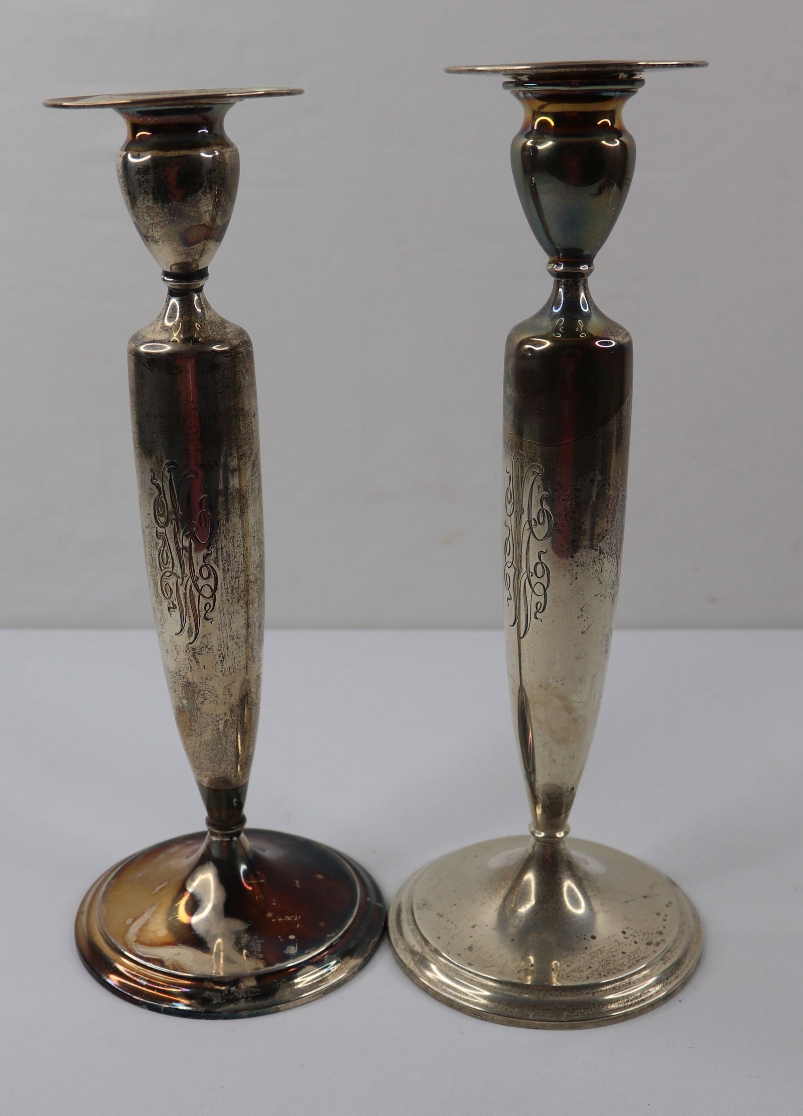 Candle Sticks, Silver Plate: Two tall matching candlesticks; No marks observed; Monogram "MMW"; Total weight 17.585 troy ounces; Measures approximately H 10 x Diameter 4 inches at base; Preowned/used items; Tarnish visible on one