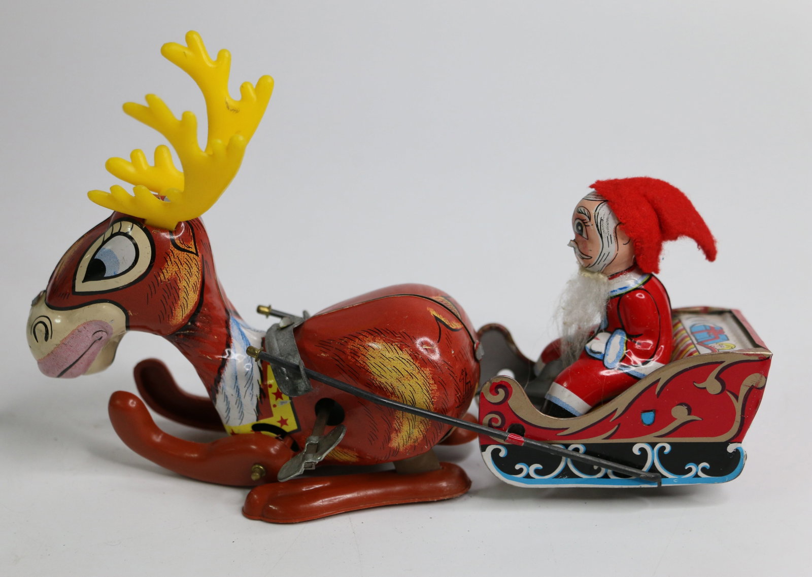 Mikuni,Tin Litho Toy: Vintage metal wind-up toy with Santa in sleigh and reindeer; Measures approximately H 4 1/2 x W 7 x D 2 inches; Item preowned, wear commensurate with age; Winds but does not move without being touched