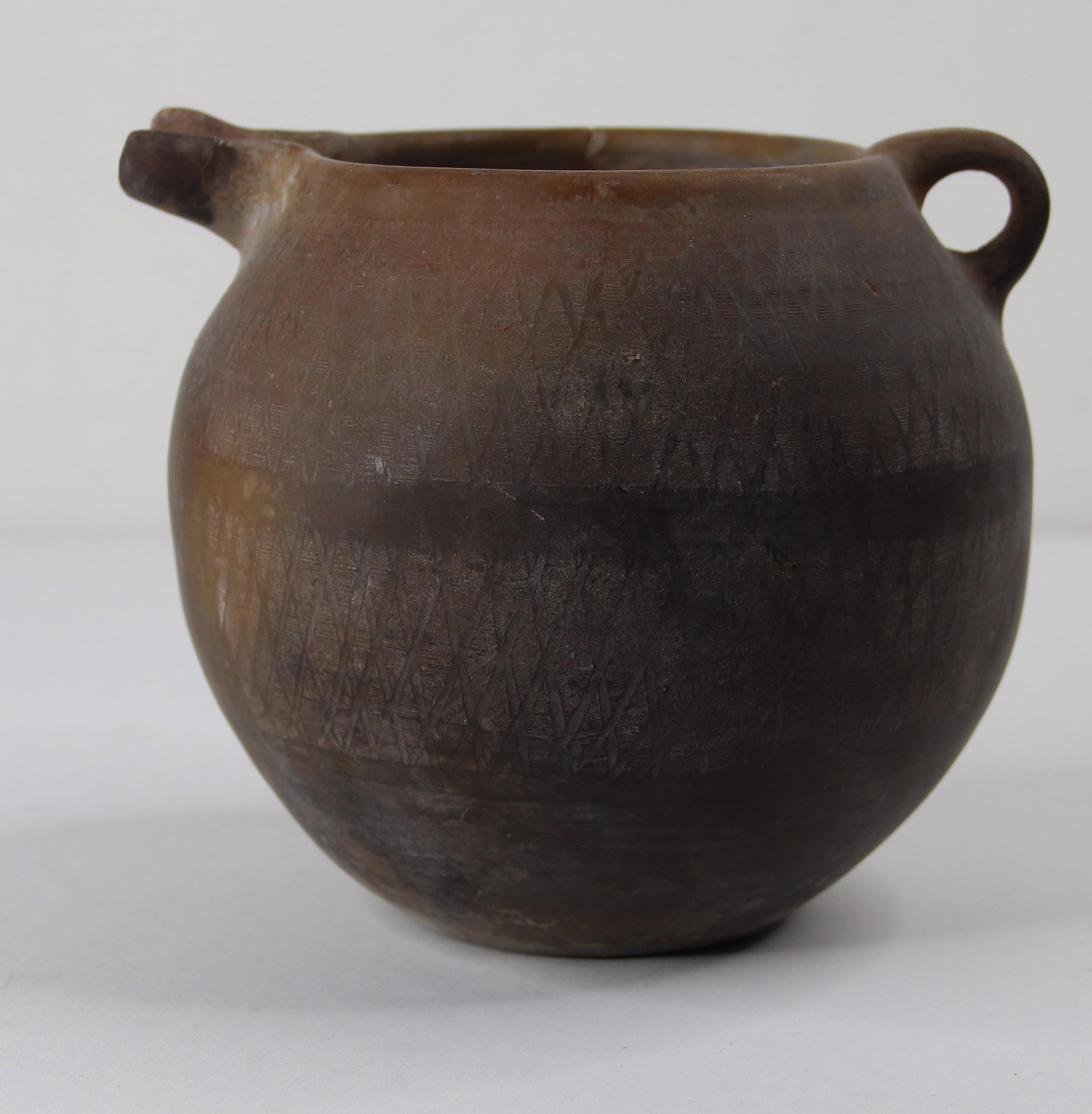 Amlash, Pitcher: Ancient artifact possibly Amlish (Marlik) N. Iran pitcher; Measures approximately H 5 1/2 x Diameter 6 & 1/2 inches from handle to spout; Ancient item with wear commensurate with age; Small rim chip o