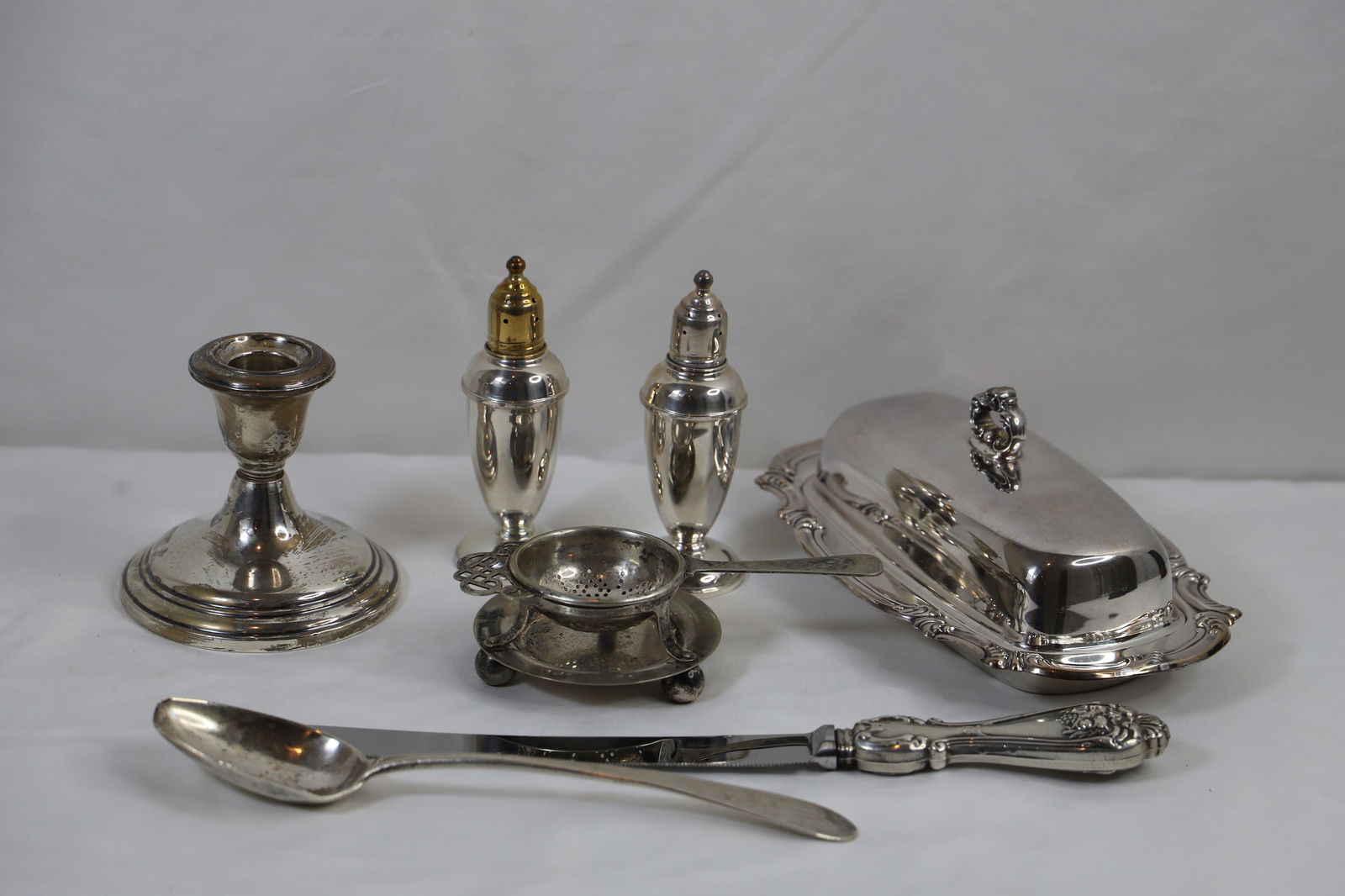Weighted Sterling, Silverplate: Reed and Barton weighted salt and pepper, One weighted candle stick; Silverplate butter dish by Gorham measures approximately H 3 x W 8 1/4 x D 5 inches; Items in used condition, some are tarnished; S