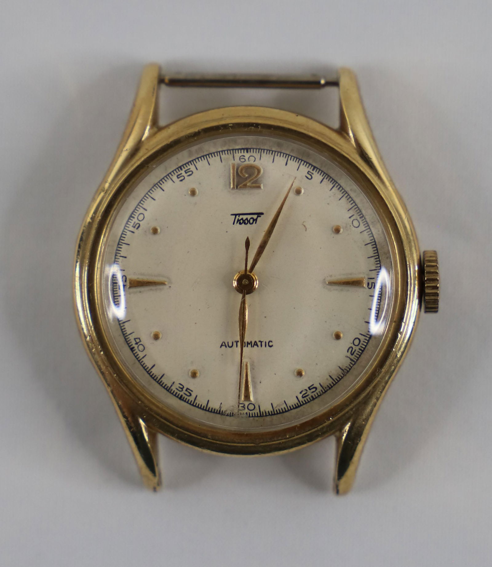 Tissot, 14K GF Watch: Wrist watch in 14K Gold Filled case by Tissot; Automatic movement; Measures approximately Diameter 1 inch; Preowned item with wear commensurate with age; A couple dents on back; surface scratches on c