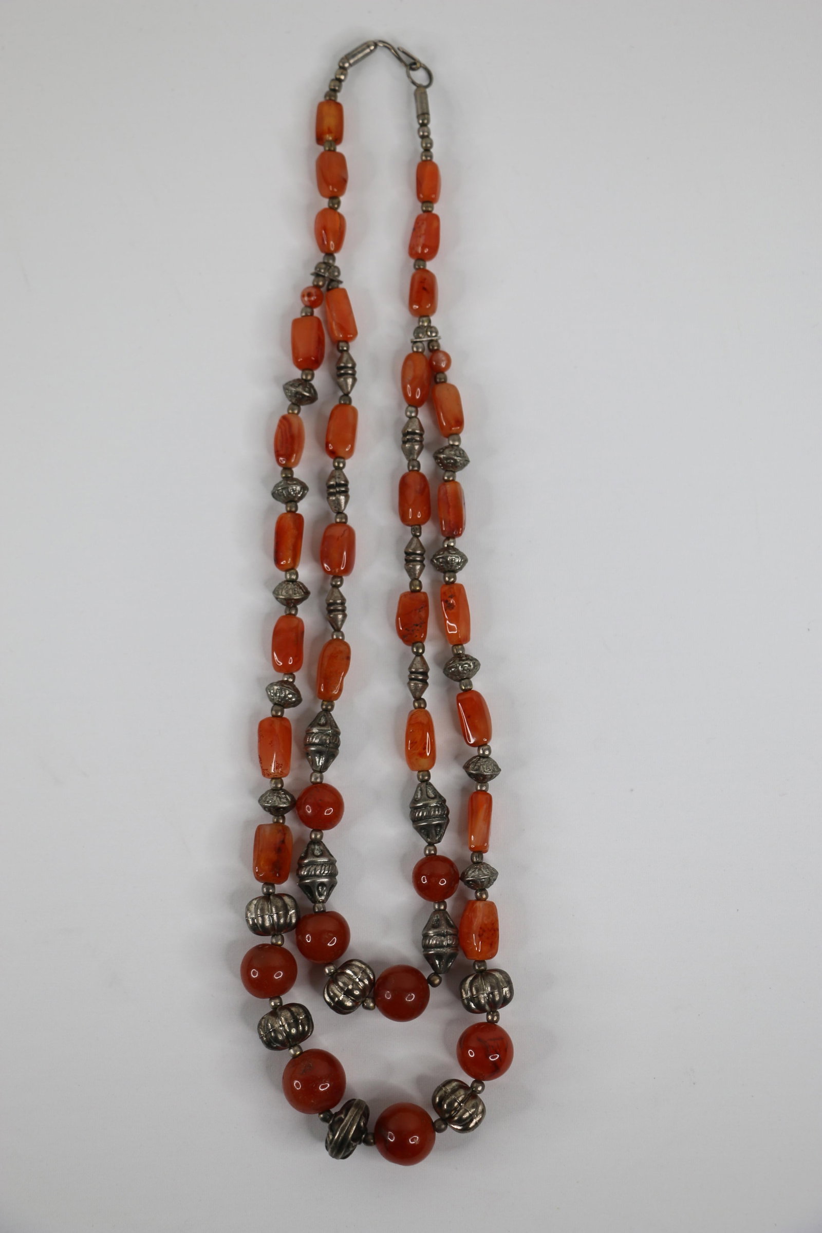 Vintage Carnelian Bead Necklace: Double strand carnelian bead and silver necklace; No marks observed; Measures approximately Length 24 inches; Preowned item with wear commensurate with age; No damage observed. See photos. Pick up in 