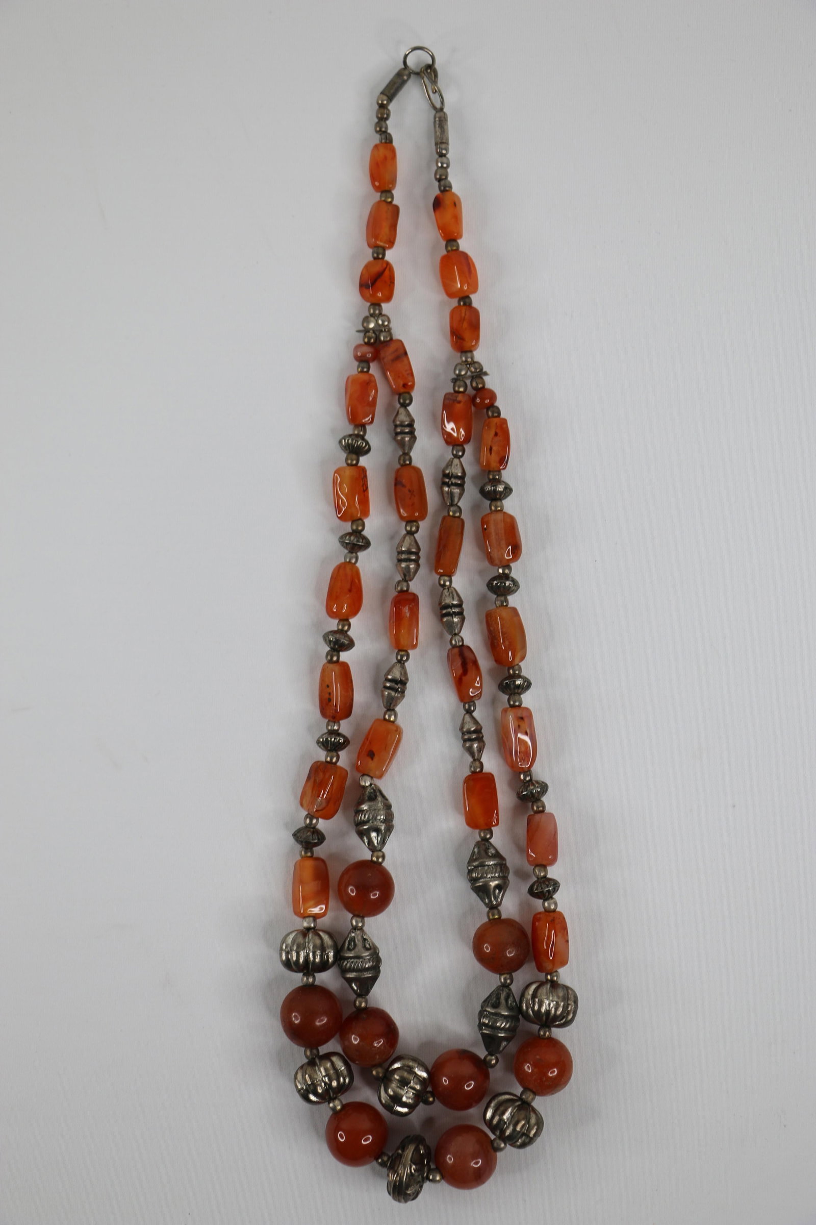 Vintage Carnelian Bead Necklace: Double strand carnelian bead and silver necklace; No marks observed; Measures approximately Length 24 inches; Preowned item with wear commensurate with age; No damage observed. See photos. Pick up in 