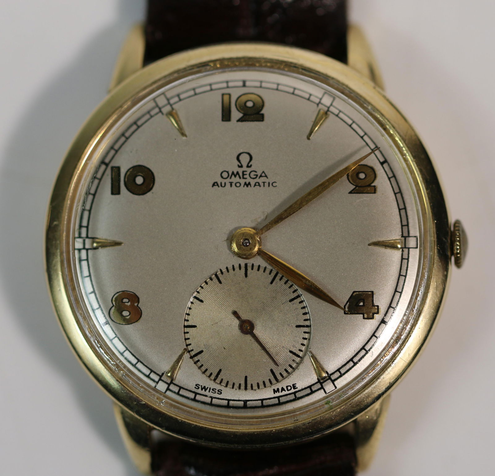 Omega, Watch: Vintage wrist watch by Omega, automatic with separate second hand; Leather band made in Argentina; Measures approximately Diameter 1 1/4 inches, band measures approximately Length 8 1/2 inches; Preown
