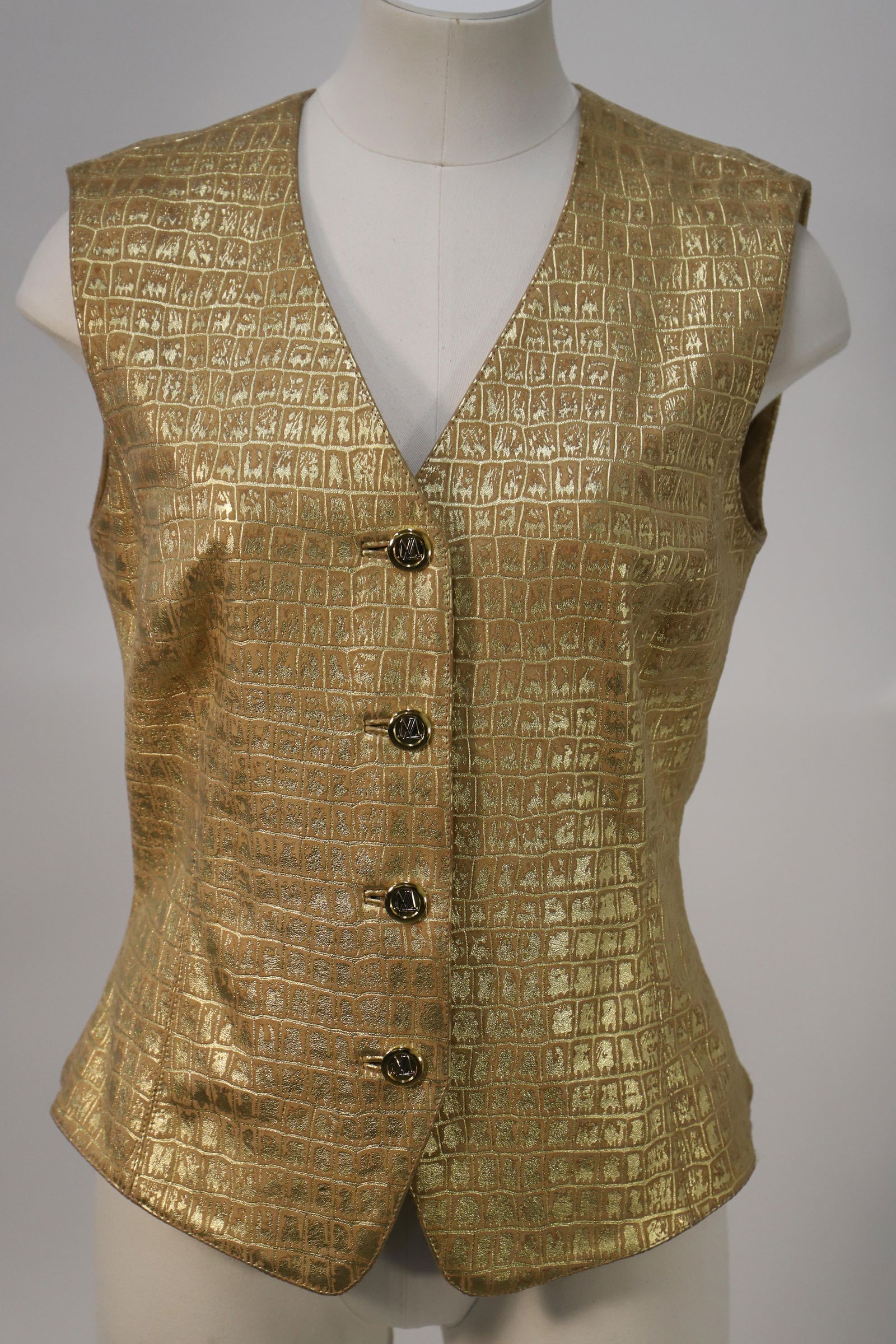 Escada, Ladies Leather Vest: Ladies gold leather vest, button closure; Size 40; Preowned, no damage observed. See photos (Please note, this item has not been authenticated)