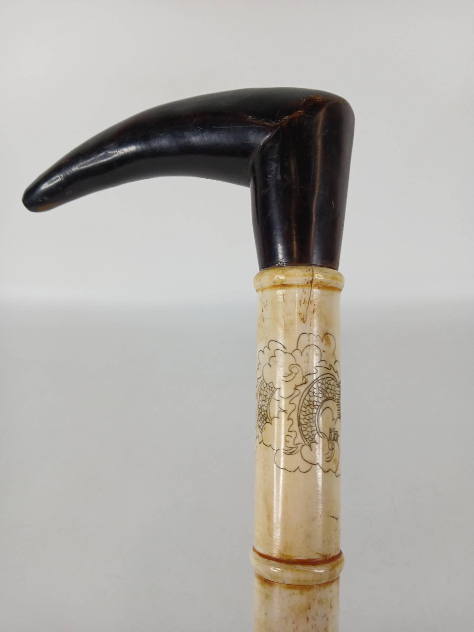 Asian Style Cane: Victorian era cane (c) 1860-1900; Carved bone shaft, bone handle, wood ferrule with rubber cover; No maker marks observed; Measures approximately H 34 1/2 inches; Wear commensurate with age. See photo