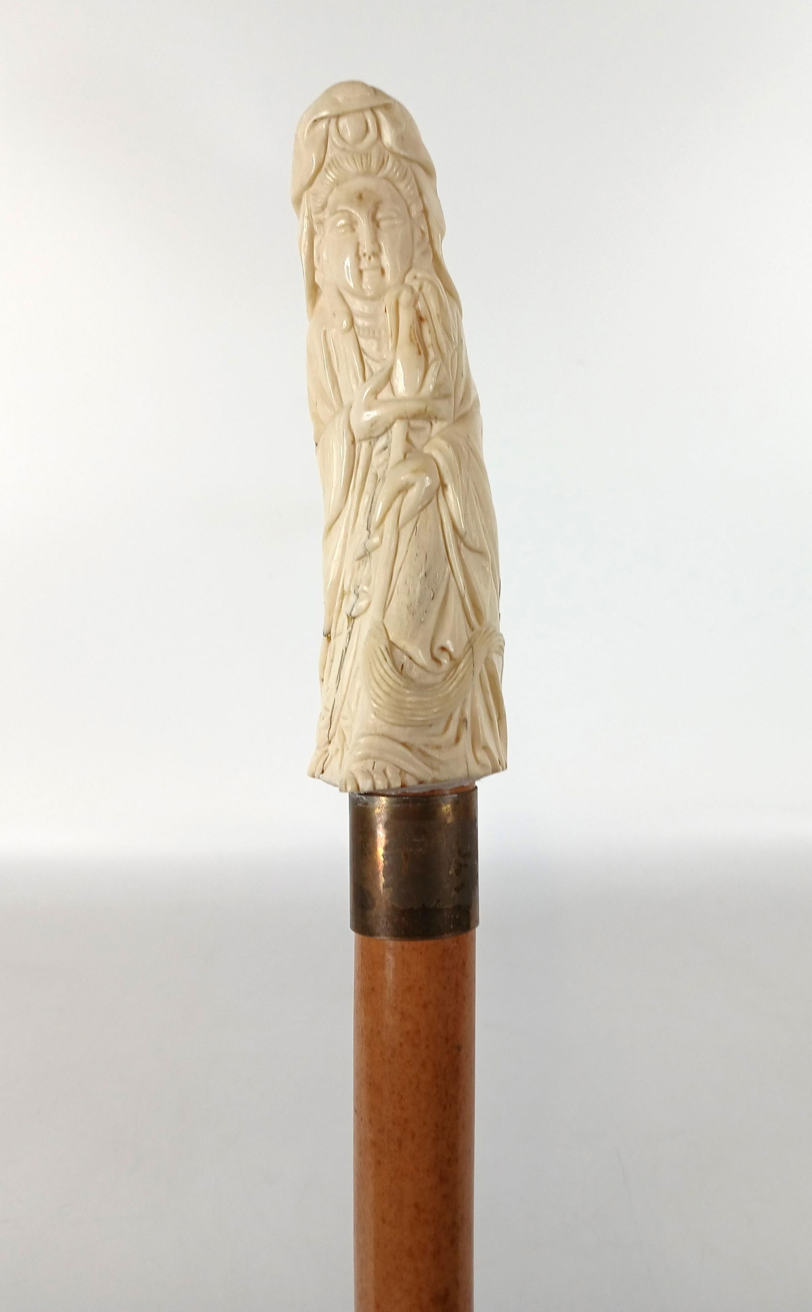 Asian Style Cane: Victorian era cane (c) 1860-1900; Bleached bone, Buddhist female carved on handle, metal collar, wood shaft, bone ferrule; No maker marks observed; Measures approximately 38 inches; Wear commensurate