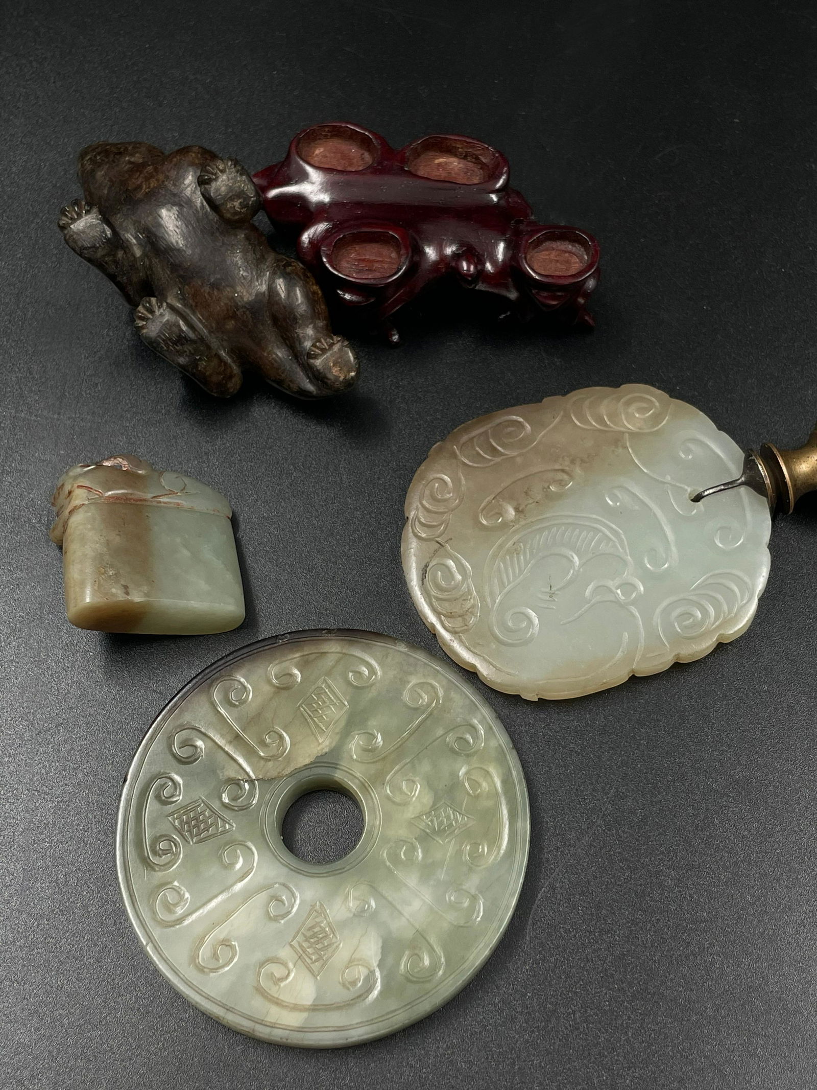 A group of jade: Chinese export jade lamp final, jade: Qing dynasty, antique Chinese lamp final with dragon pattern. A brownish jade beast with original hongmu stand. Jade seal. Dimension: Various szies. Largest jade beast approximately L 2.5in (6.5cm).Pr