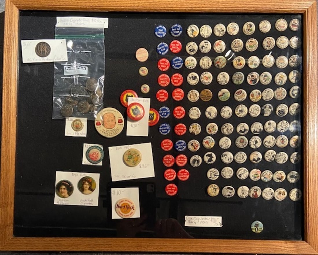 Early 1900's Cigarette Pins, Military Buttons and Other Memorabilia: Artist: Unknown Title: Early 1900's Cigarette Pins, Military Buttons and Other Memorabilia Medium: Display Case Art Dimensions: 18 x 22 x 2 inch Source: www.qart.com Condition Report: Good. Wear