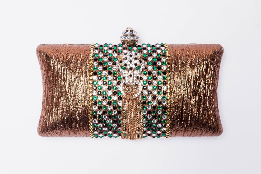 Mercedes Brunelli "Wildcat Tassel" Clutch (Gold): Presenting this Mercedes Brunelli work: "Mercedes Brunelli "Wildcat Tassel" Clutch (Gold)". This piece, measuring 3.75 x 7.5 x 2 inch, is available at auction on LiveAuctioneers. Artist: Mercedes Brun