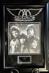 Signed Aerosmith Promo Plaque: Signed Aerosmith Promo Plaqueis a framed collectible and signed by Steven Tyler, Joe Perry, Tom Hamilton, Joey Kramer and Brad Whitford. Due to the reflective nature of the glass, some textures