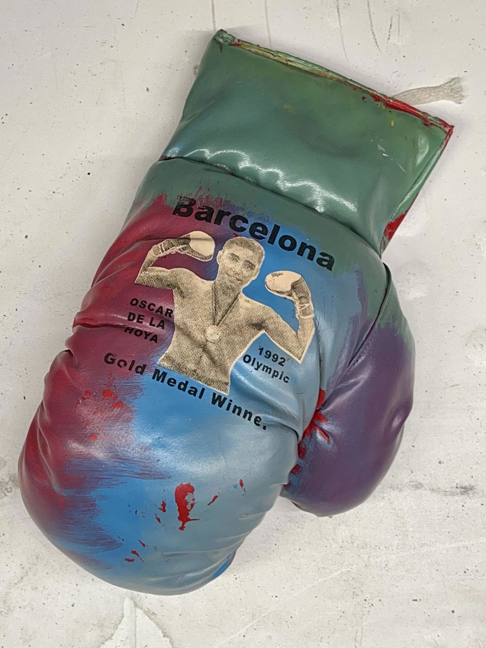 Oscar De La Hoya Gold Medal Winner by Steve Kaufman: Oscar De La Hoya Gold Medal Winner by Steve Kaufmanis a one of a kind mixed media boxing glove collectible hand signed by Steve Kaufman. Steve Kaufman was the apprentice of Andy Warhol. This piece cam