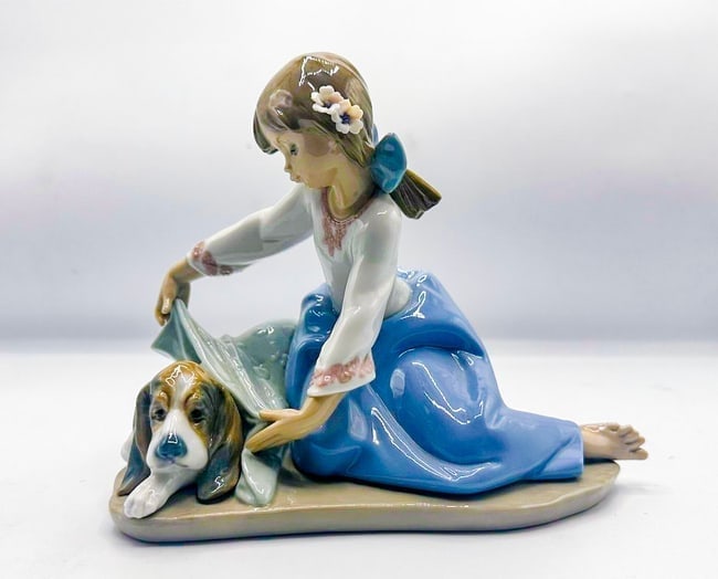 Dogs Best Friend 1990, Lladro: Dogs Best Friend 1990, Lladro Is a glazed porcelain figurine stamped Lladro, Spain. This piece is in excellent condition. Measures 8 x 6 x 5 in.
