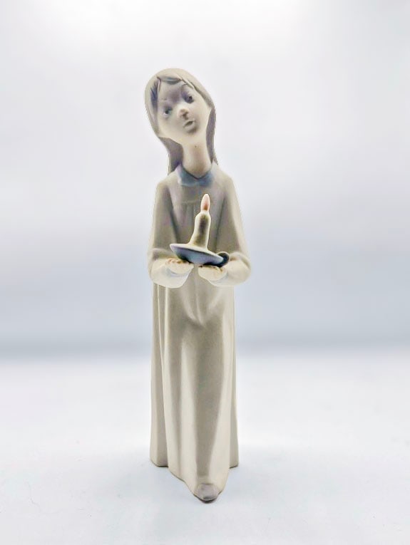 Girl with Candle, Lladro: This Lladró porcelain figurine is model #4868, officially titled "Girl with Candle" (Spanish name: "Niña en Palmatoria" or similar variations like "Nina En Palmatoria").Sculptor: Fulgencio