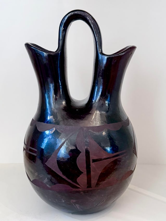 Contemporary Iridescent Blackware Wedding Vase,: Handcrafted ceramic wedding vase in classic double-spout Pueblo-inspired form, featuring a high looped handle uniting two flared spouts above a globular body. Dramatic iridescent glaze shifts from dee