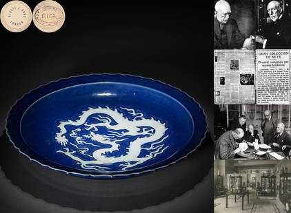 A Chinese Blue and White Reserve Decorated Dragon Dish: A Chinese Blue and White Reserve Decorated Dragon Dish D: 17 1/8 in. H: 2 1/2 in. (43.5 cm x 6.5 cm) George Eumorfopoulos (1863-1939) Collection. In 1934, Bluett & Sons acquired items from the