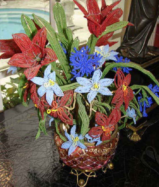 Cranberry Glass W/ Beaded Flowers, As is.: The cranberry glass planter, held in a brass wired frame, the glass in several pieces, nice antique glass beaded flower garniture.