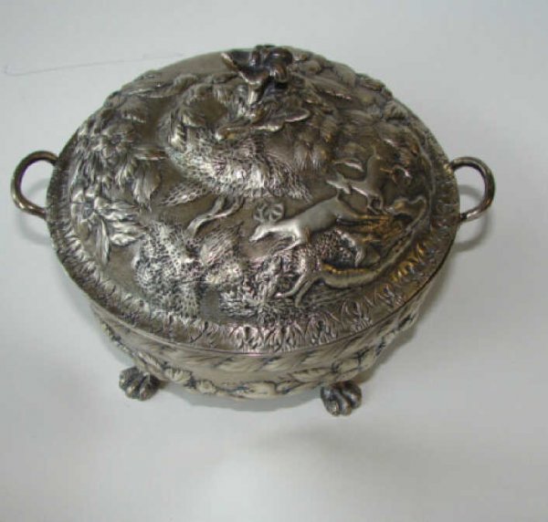 Sterling Silver S. Kirk and Son Butter Dish.: A beautiful hand chased covered butter dish of round form with stags in landscape and floral repousse lid, floral finial, the body with two handles, on four paw form feet., Interior removable strainer