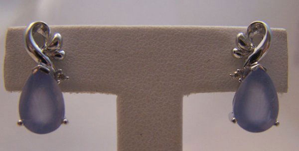 Ladies 14 Karat White Gold Moonstone Earrings: 70.) Ladies 14 Karat white gold Moonstone and Diamond fashion earrings. The earrings are composed of centered prong set Pear shape Moon stone measuring 10x7mm highlighted round brilliant cut diamonds