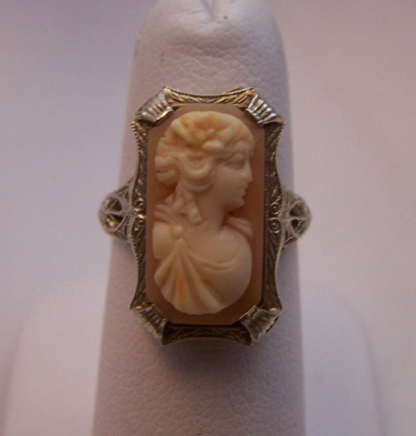 Ladies 14K White Gold Estate Cameo Ring.: Ladies 14K White Gold Estate Cameo Ring. Antique style cameo right with filigree setting rectangle shape cameo, 16.3 x 8.7 mm. peach coloring stone. Sizable, current size 5.5. [44] Weight 3.6 grams.