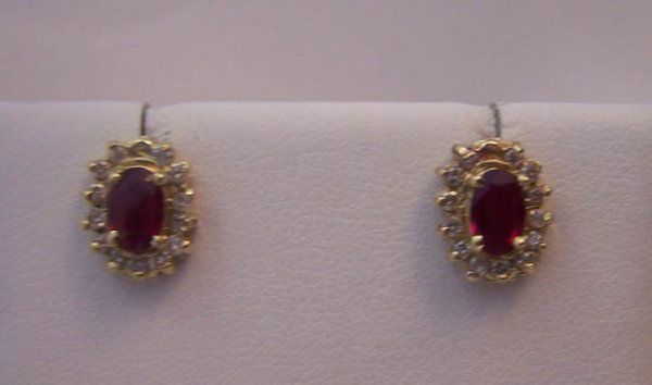 14K Yellow Gold Ruby /Diamond Earrings.: 14K Yellow Gold Ruby /Diamond Earrings. Set with emerald shaped ruby with .25 carat prong set round cut diamonds set below the ruby and comprising the outer edge of the earrings. [awe 0798]