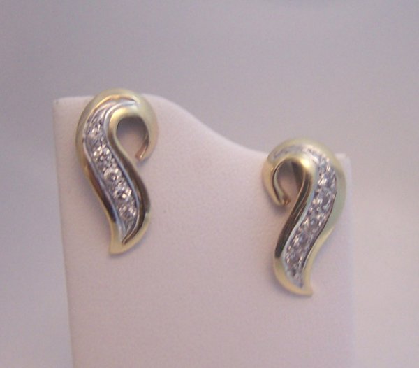 Ladies 14K Titanium Diamonds Earrings.: Ladies 14K Titanium Diamonds Earrings. Scroll shaped with round bead set diamonds, screw backs, total weight 3.8 grams. [awe 0611]