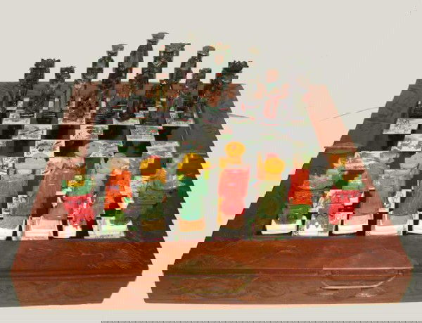 Primitive Korean carved chess set.: Hand carved and painted, this unusual chess set is complete with unique carved and painted men, checkerboard tiles of ebony, and carved case.
