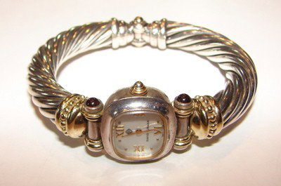 Sterling silver ladies watch. David Yurman.: Sterling silver ladies watch. David Yurman. White mother-of-pearl dial. Garnets on lugs. Cable style bracelet. Quartz movement. 56.5 grams.
