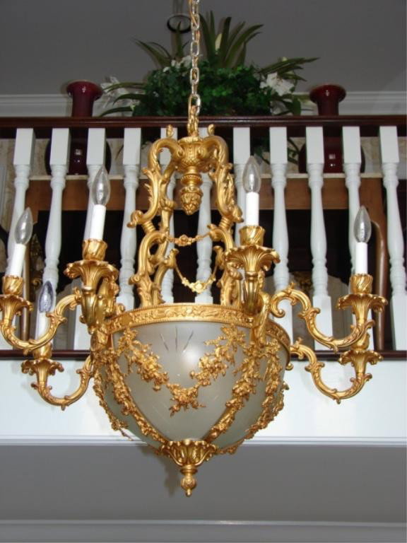 Louis XV style dore bronze and glass chandelier.: Custom 20th C. reproduction. Size: Having a frosted glass dome supported on a dore gilt bronze ring frame with 8 arm chandelier.
