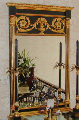 French Empire style trumeau (mirror). 20th C.: French Empire style trumeau (mirror). 20th century reproduction. H - 50", W - 32". The rectangular form mirror of ebonized wood with gilt highlights, the pediment with molded cornice, center urn and s