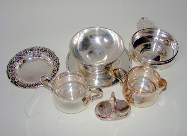 Eight ssorted sterling articles. 19tr. oz.: Assorted sterling articles. Eight pieces total including two boles, porriger, creamer, sugar bowl, salt and pepper in holder. Some minor dents. all American make 20th C. 19 troy ounces total weight.