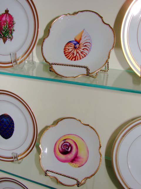 Set of four porcelain cabinet plates, Tizsak Gabor: Set of four porcelain cabinet plates, hand-painted, Tizsak Gabour, Ana Weatherly designs. Diameter 6.25". Round with scalloped gilt rim and specimen shell reserves.