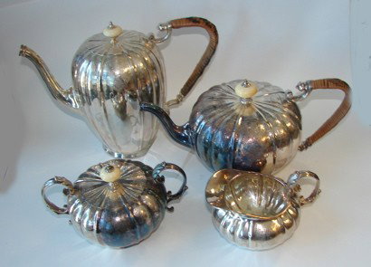 Four piece English plated tea/coffee service.: Mellon shaped body, rattan clad handles.