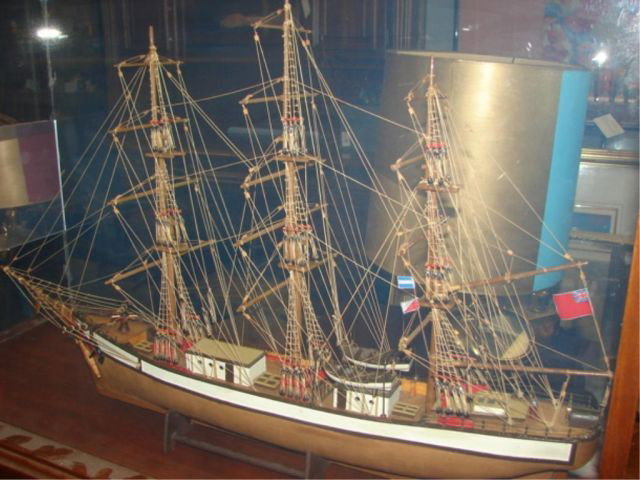 Ship's model on stand with case.: Constructed locally, with display table and case included, dedication placque.
