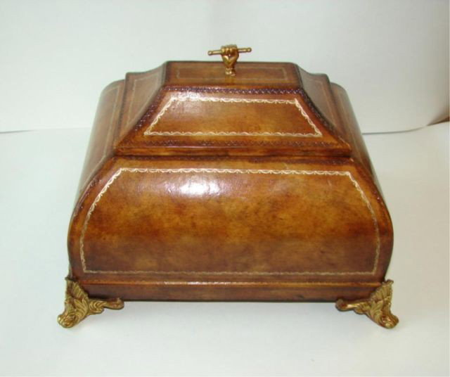 Tooled leather clad covered box.: Brass mounted, Height - 8", length - 11"