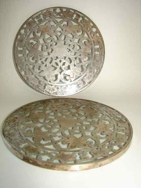 Pair of sterling silver overlay trivets.: Diameter: 6 inches.