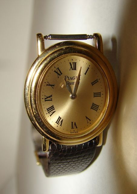 Piaget 18K Yellow Gold Ladies Dress Watch.: Oval face, on a leather dress strap.