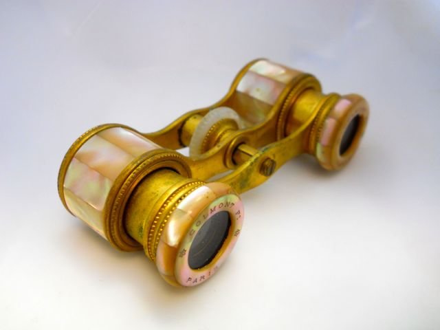 French Opera Glasses, Paris, C. 1900.: Brass, having Mother-Of-Pearl detailing, with the manufacturer "Colmont, Paris" engraved into the mother of pearl. original leather case.