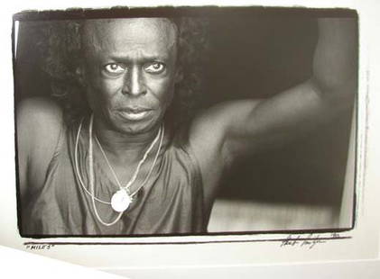 MILES DAVIS BY HERB SNITZER.: H - 12, W - 17" (plate size). Black and white photo by Herb Snitzer dated 1990. Glazed, mounted and framed.