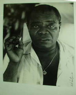 HERB SNITZER PHOTOGRAPH, LOUIS ARMSTRONG.: HERB SNITZER PHOTOGRAPH. H - 12 1/2, W - 9 3/4" (plate size). Dated 1960. Edition 62/95. Matted and framed under glass.